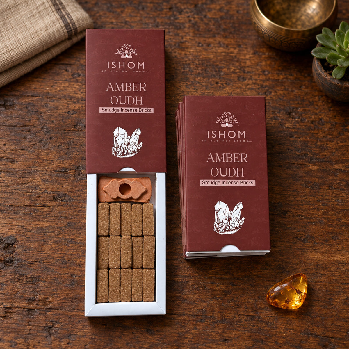 Open ISHOM Amber Oudh incense box showing 15 smudge bricks and burner