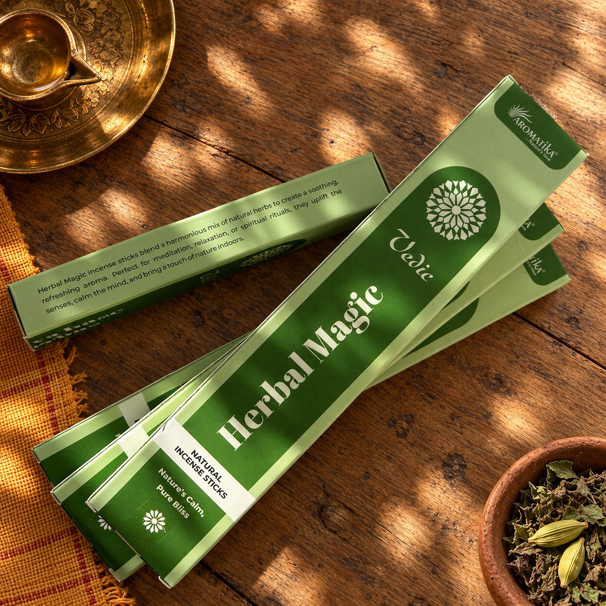Aromatika Herbal Magic natural incense stick boxes displayed with herbs on a rustic Ayurveda inspired bohemian wood