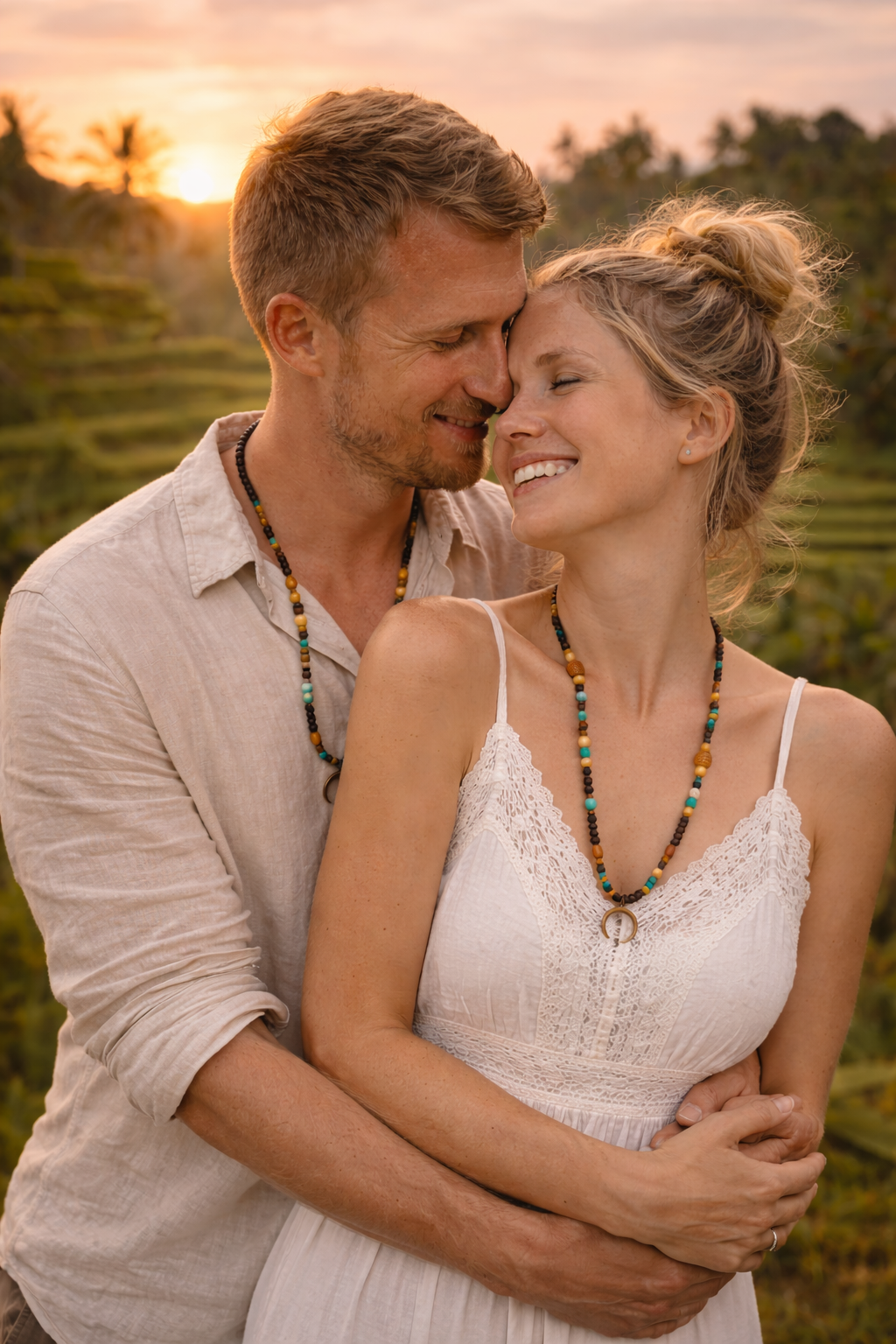 Models wearing a long boho beaded necklace with a dark crescent pendant in  a Balinese background. Unisex design. 
