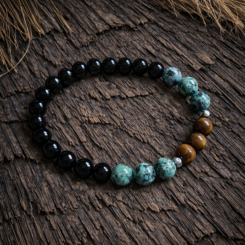 Boho crystal bead bracelet with black obsidian-look beads, African turquoise-look beads and golden tiger’s-eye-look accents on a dark bamboo background