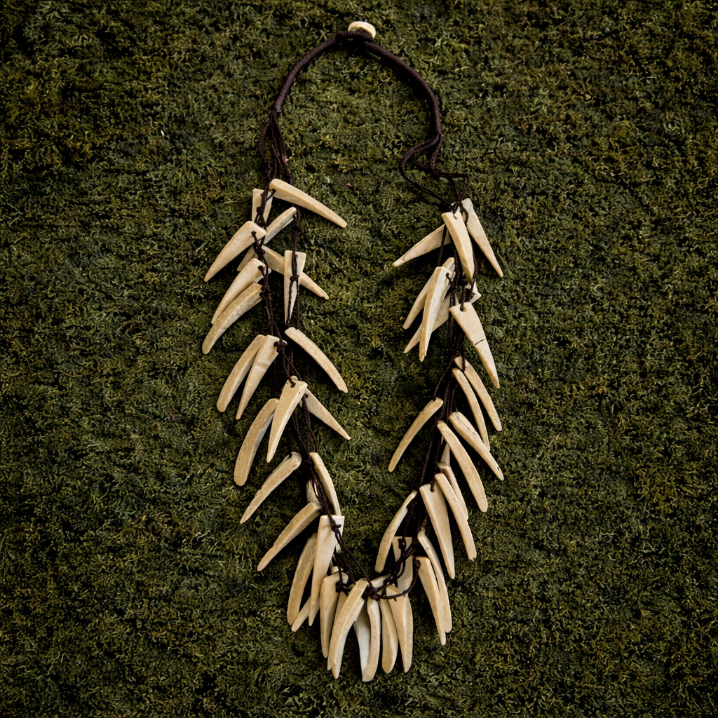 Boho bone-look fang necklace with layered cream-coloured pendants on dark cord