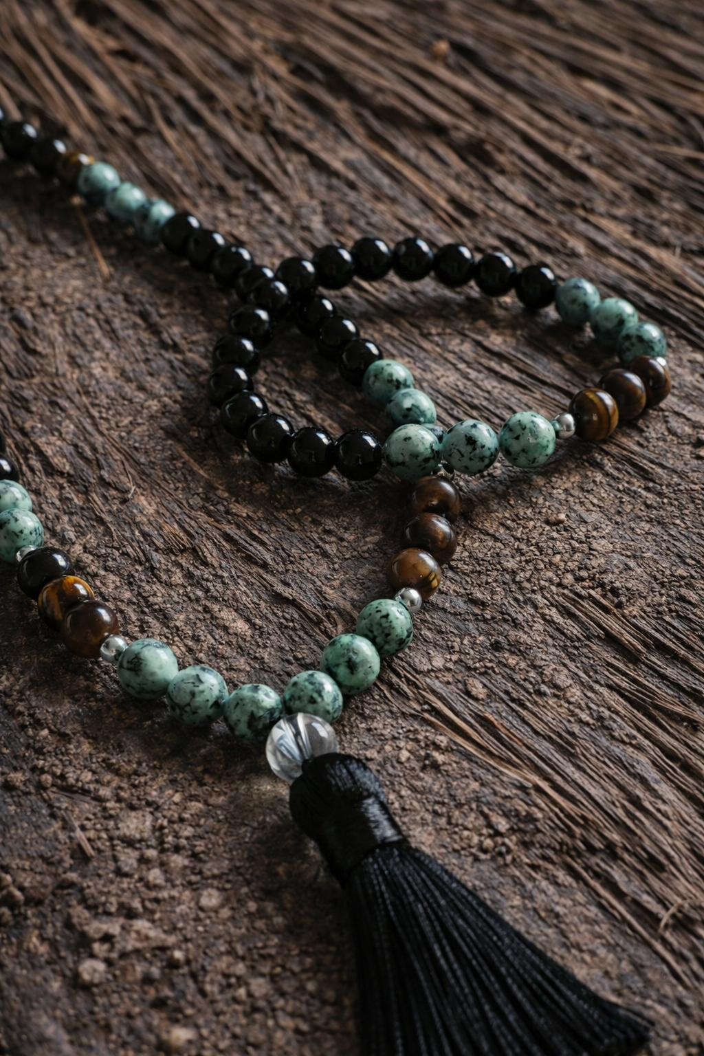 Close-up of matching boho necklace and bracelet with obsidian-look, African turquoise-look, tiger’s-eye-look and clear quartz-look beads.