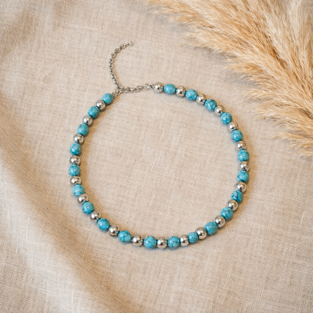 Boho festival wear necklace with turquoise-look round beads, silver-tone spacer beads and an adjustable chain matched on linen