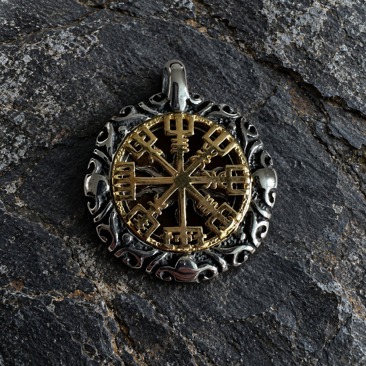 Front detail of Nordic-inspired double-sided pendant with gold compass motif and sculpted silver-tone border.
