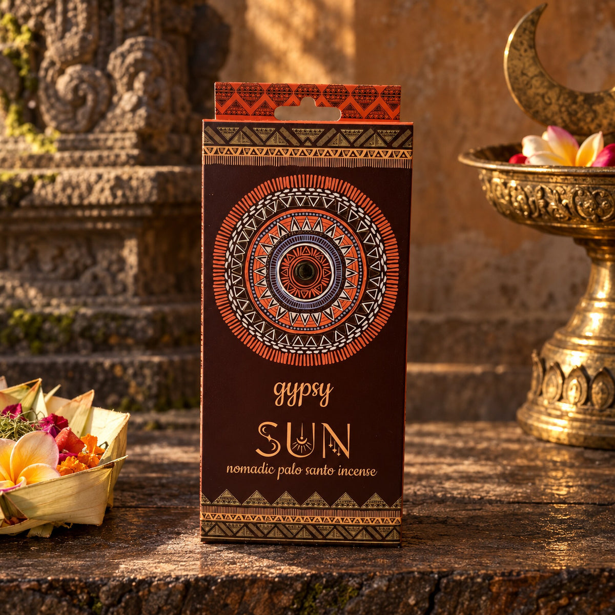 Gypsy Sun Nomadic Palo Santo incense package displayed in a warm bohemian ceremonial-inspired setting.