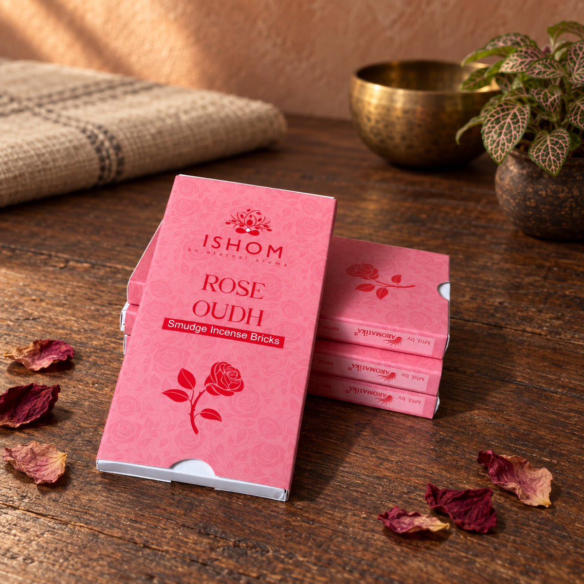 ISHOM Rose Oudh smudge incense bricks in pink packaging with dried rose petals