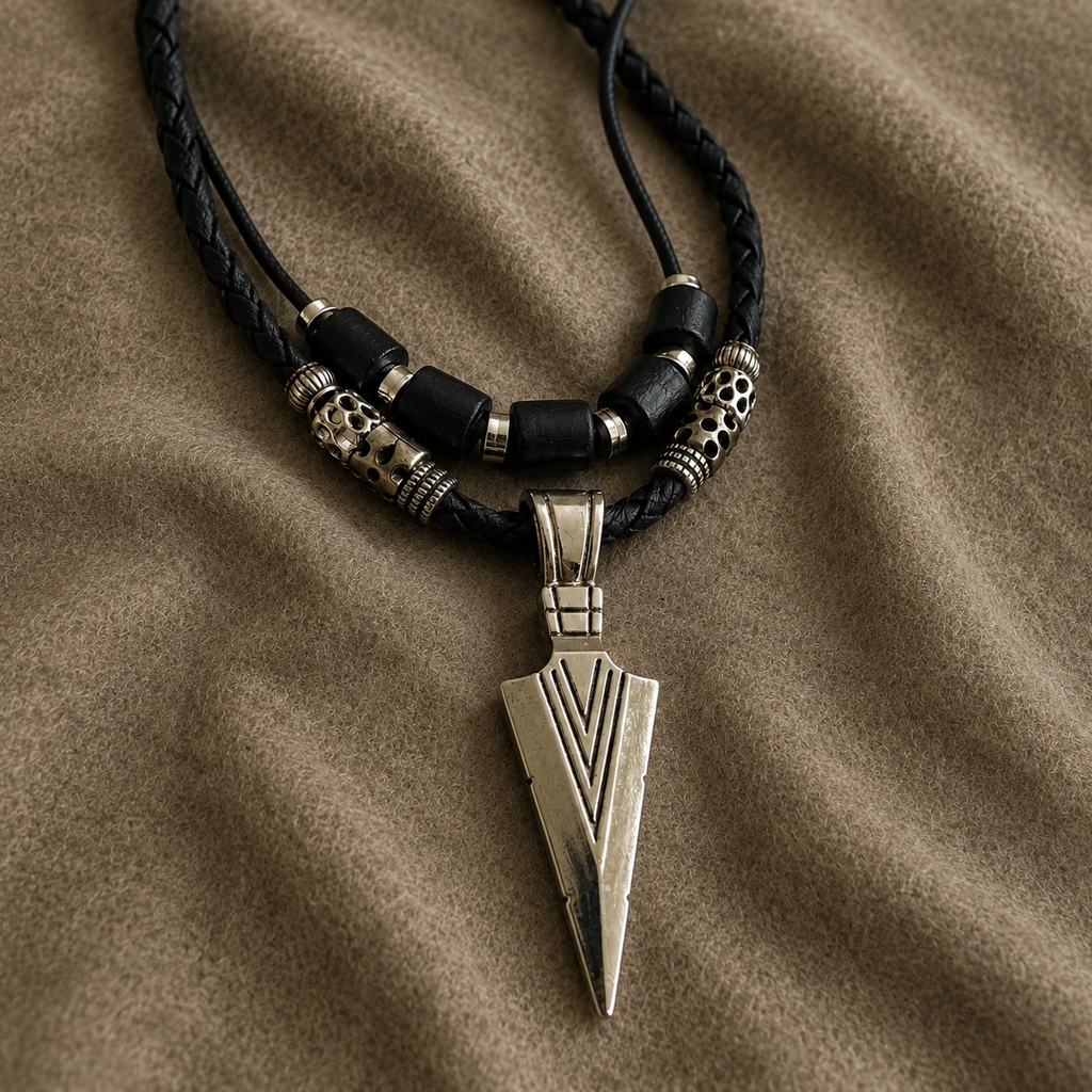 Adjustable Nomad Arrow pendant necklace displayed on soft fabric background