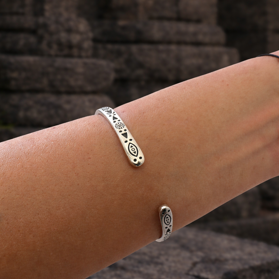 Close-up of the Padang Padang Pulse Cuff Bracelet worn on the wrist, showing silver-tone eye and geometric details
