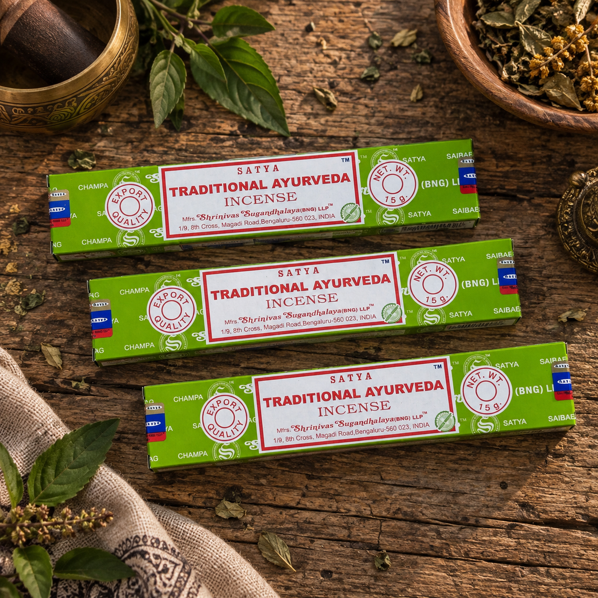 Satya Traditional Ayurveda Incense Sticks 15g displayed on a rustic wooden surface with dried herbs and botanical leaves.