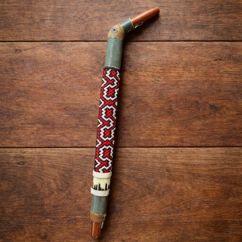 Full view of a Tepi Hapé applicator with red, black and white geometric beadwork